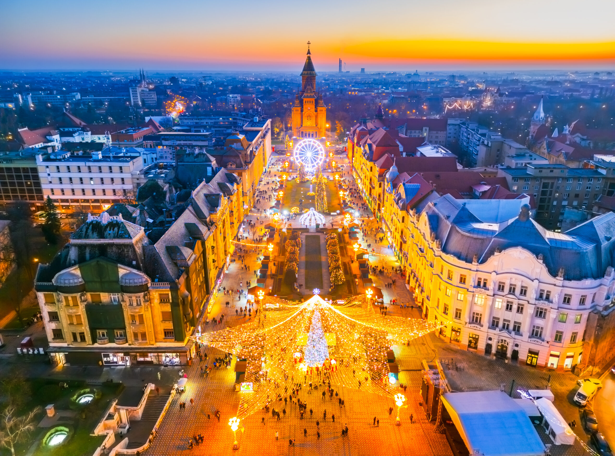 Timisoara, Romania. Aerial drone view of Christmas Market, festive wonderland with twinkling lights, local crafts, delicious food, and winter seasonal entertainment.